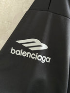Balenciaga long-sleeve shirt sleeve close-up with white balenciaga logo on black