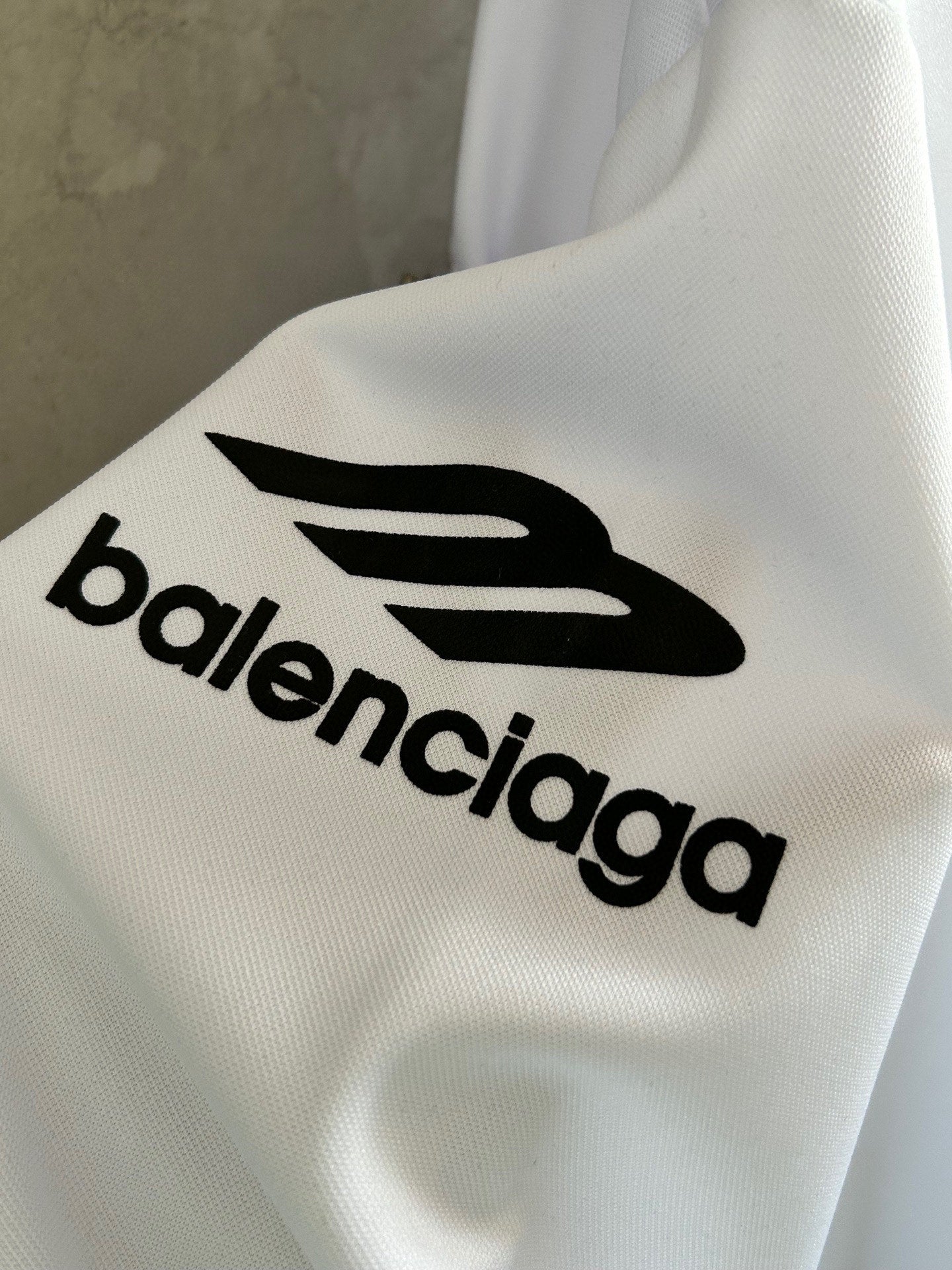 Balenciaga logo print on white sleeve of long-sleeve top