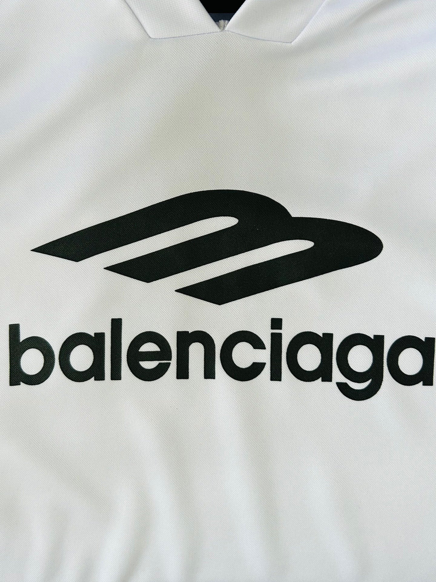 Balenciaga logo on white long-sleeve V-neck top