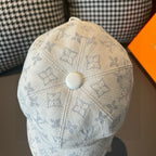 Light beige monogram canvas cap with round top button and blue patterned crown