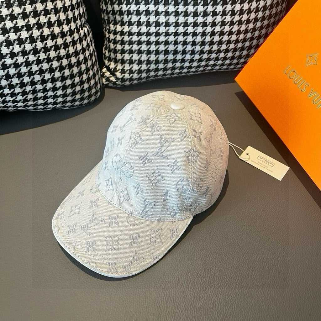 Light beige monogram canvas cap with blue pattern, curved brim and top button