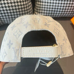 Light beige monogram canvas cap with Louis Vuitton label on adjustable strap
