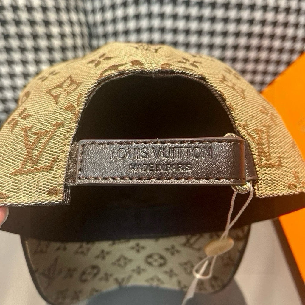 Tan monogram baseball cap with inner band labeled “LOUIS VUITTON”