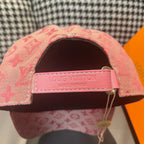 Pink monogram baseball cap showing interior label and adjustable strap