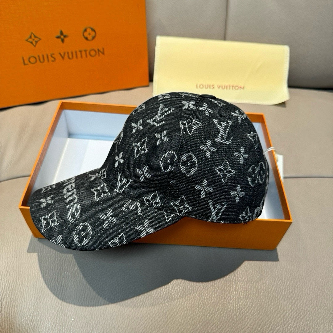 Black monogram cap with Supreme lettering, curved brim, box view.
