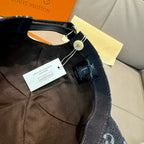 Black cap strap and buckle with small round logo tag.