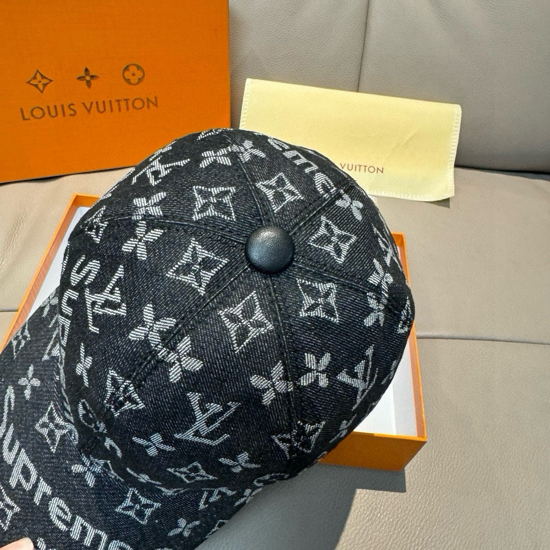 Black monogram cap with front button, Supreme and LV-style icon pattern.