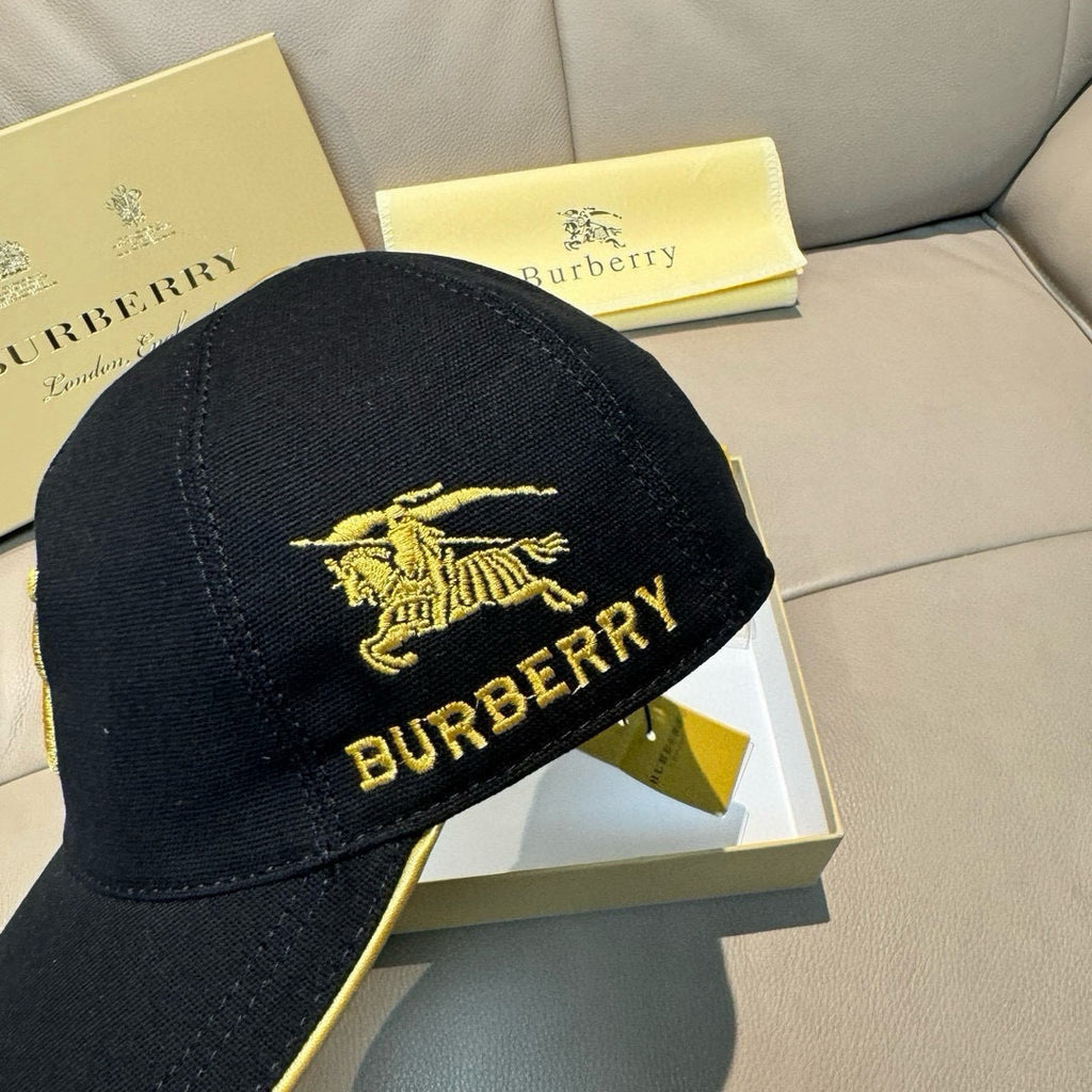 Burberry cap in black with gold horse emblem and "BURBERRY" lettering, front view.