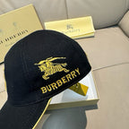 Burberry cap in black with gold horse emblem and "BURBERRY" lettering, front view.