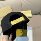 Burberry cap in black with a tan leather logo patch on the back.