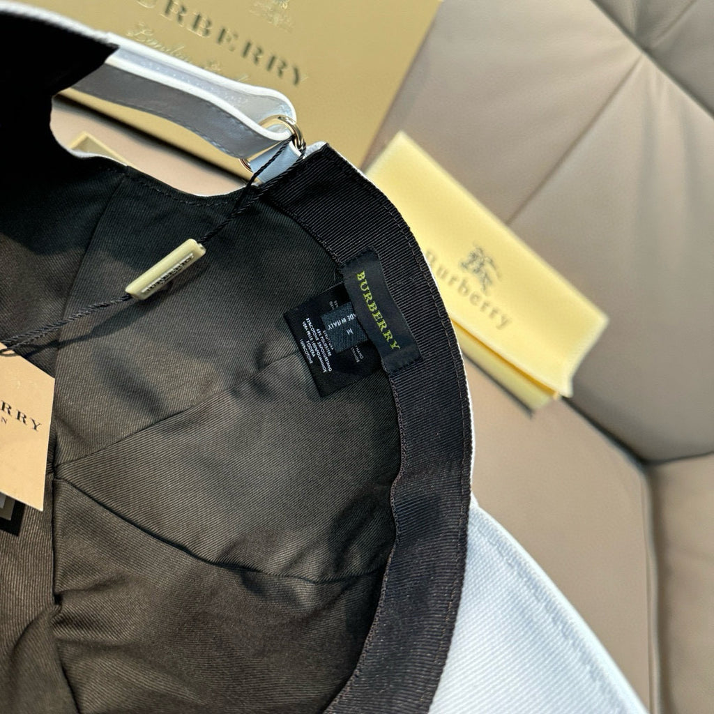 Black Burberry cap interior with adjustable strap and hanging label