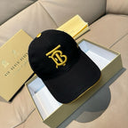 Burberry cap in black with gold TB logo on the front panel.