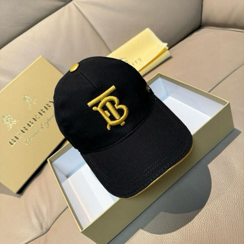 Burberry cap in black with gold TB logo on the front panel.