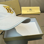 White Burberry baseball cap side view with gold B monogram embroidery