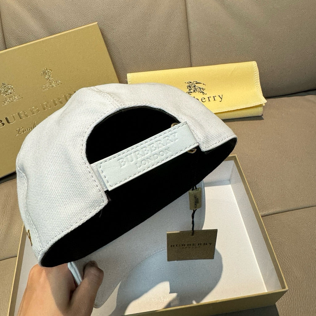 White Burberry baseball cap interior view with adjustable strap and B badge
