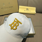 White Burberry baseball cap with gold B monogram emblem on front