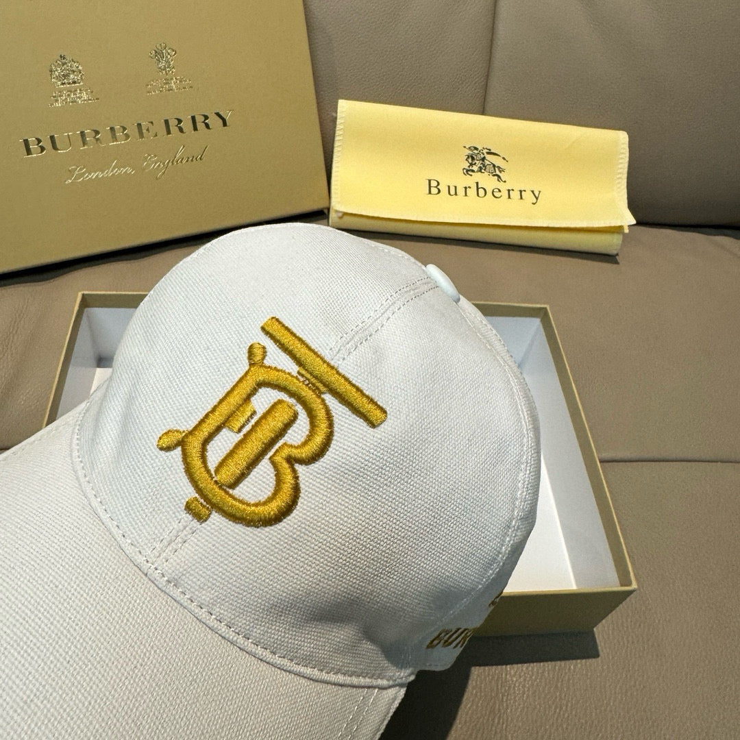 White Burberry baseball cap with gold B monogram emblem on front