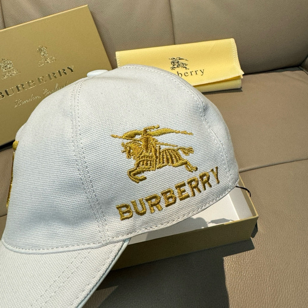 White Burberry baseball cap with gold horse emblem and BURBERRY lettering