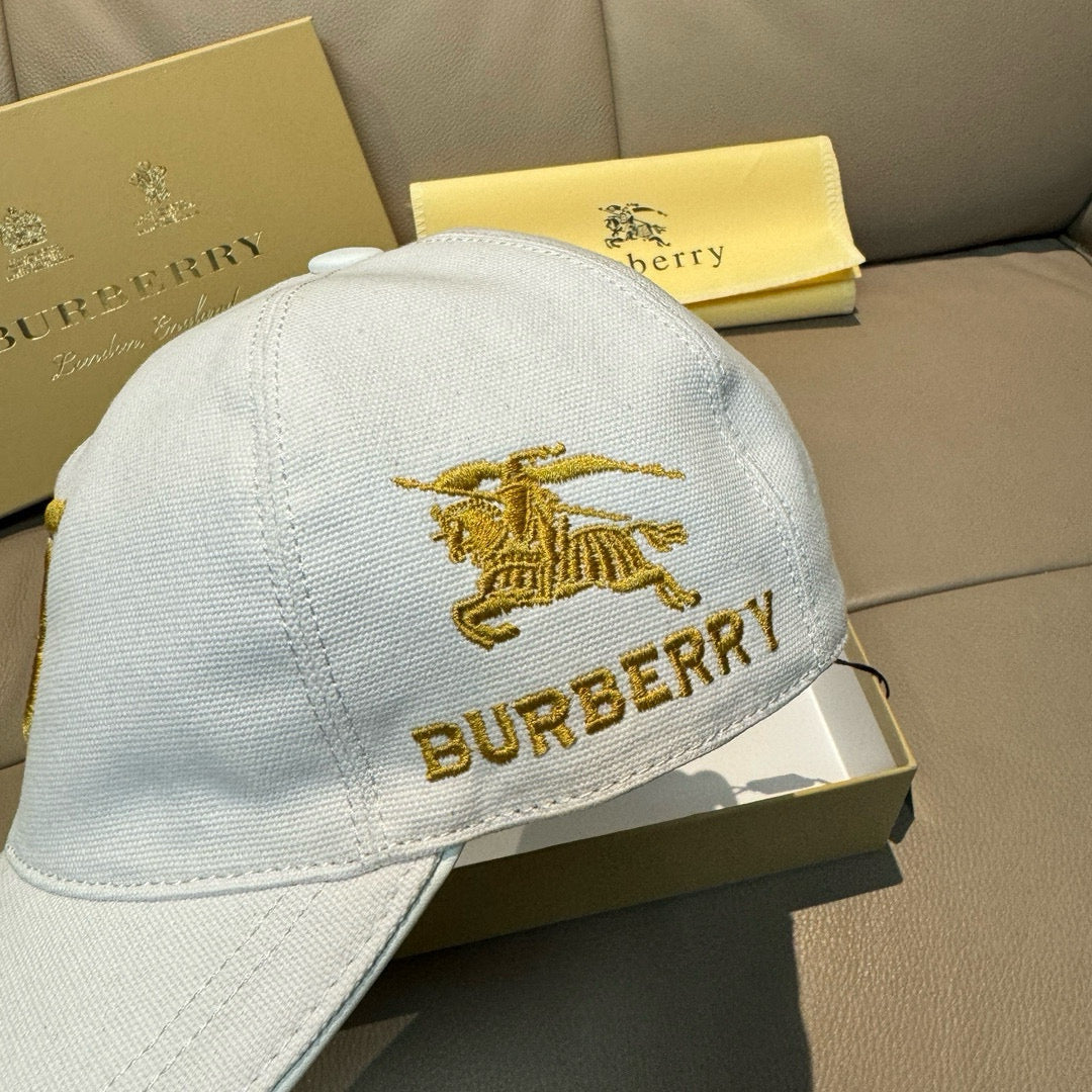 White Burberry baseball cap with gold horse emblem and BURBERRY lettering