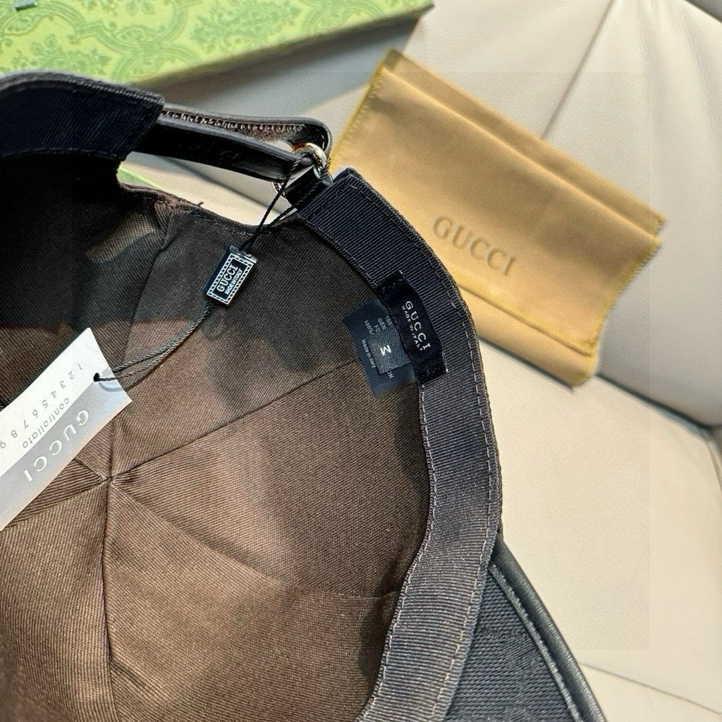 Black Gucci cap interior with adjustable strap and attached care label tags