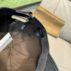 Black Gucci cap interior with adjustable strap and attached care label tags