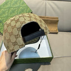 Gucci GG baseball cap side view, beige canvas with black interior panel and Web trim