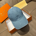 Blue denim monogram baseball cap with curved brim and stitched seams