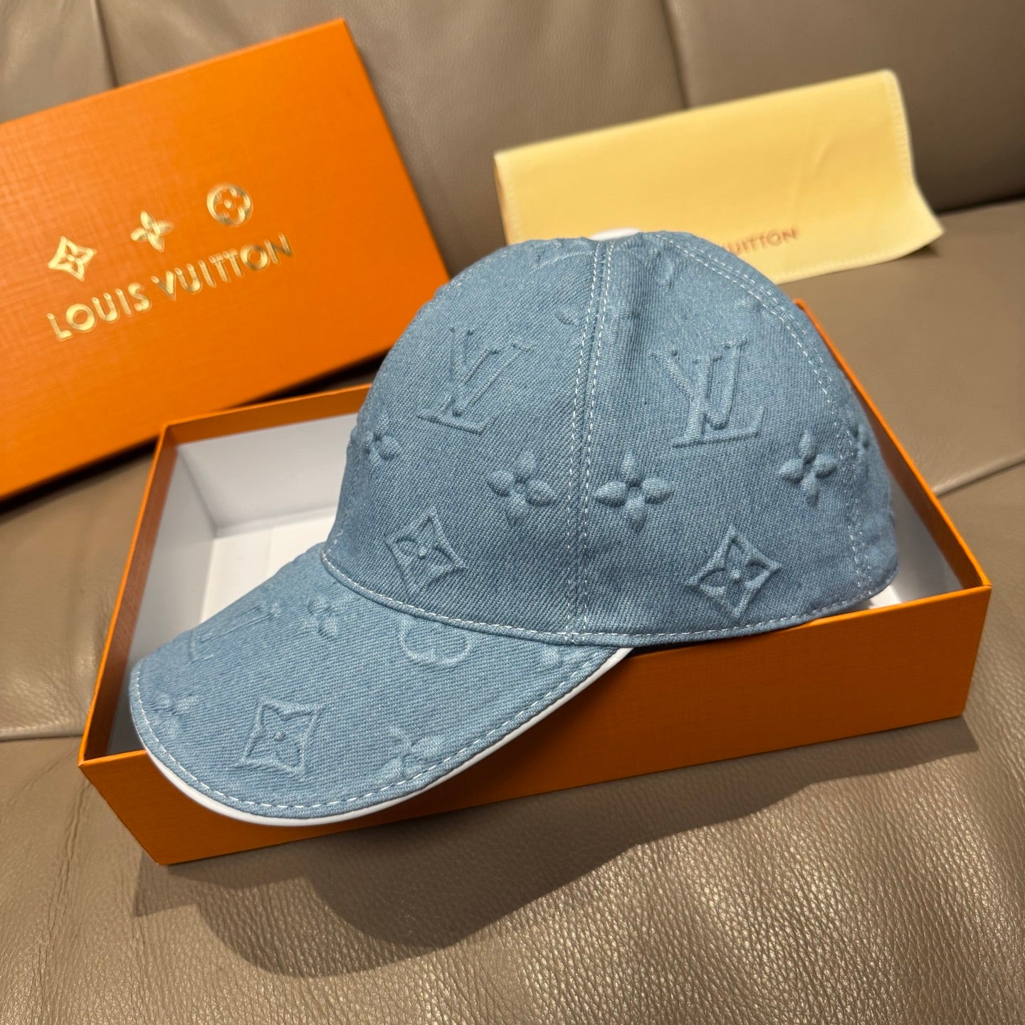 Blue denim monogram baseball cap, side view with curved brim