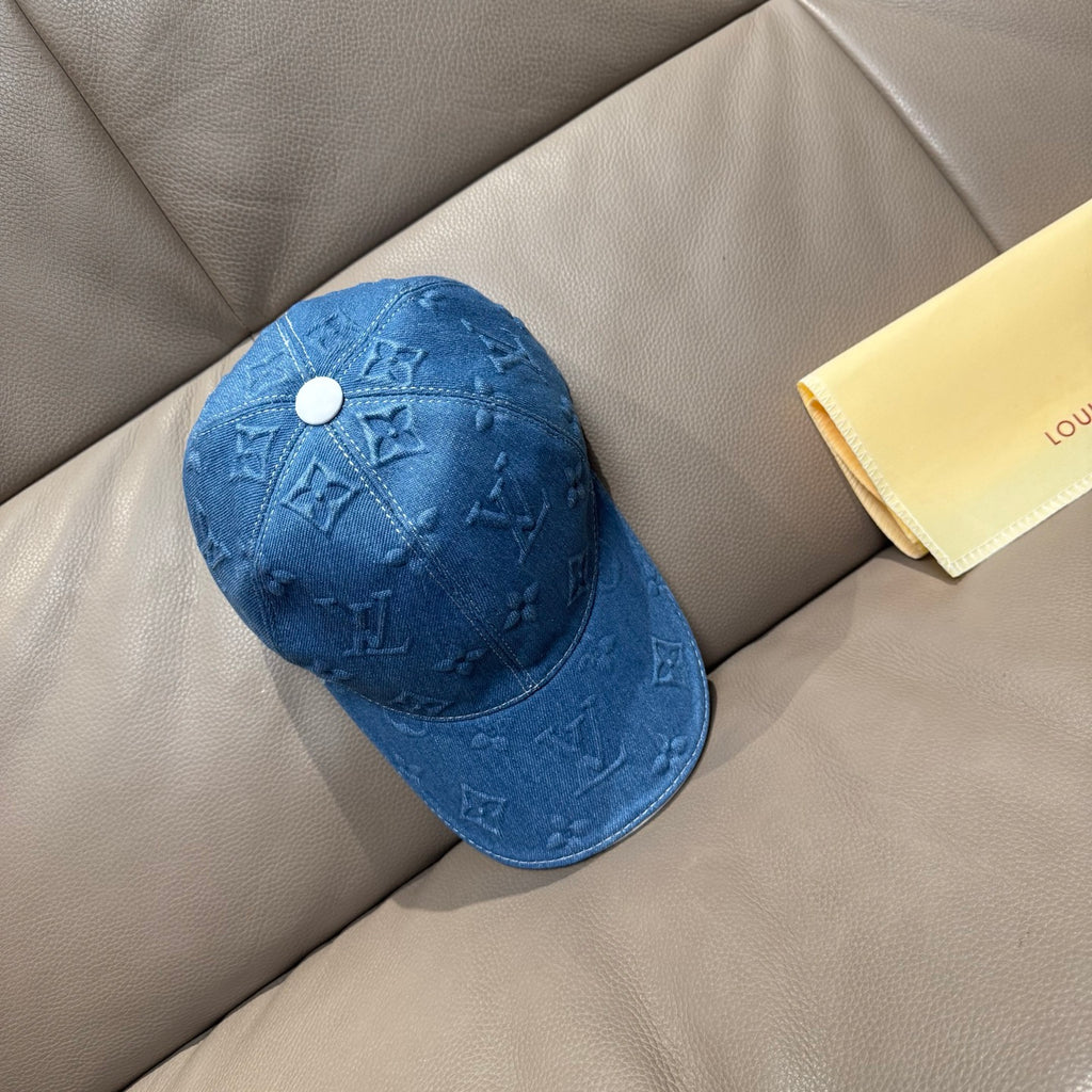 Blue denim baseball cap with embossed monogram motifs and white snap button