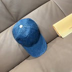 Blue denim baseball cap with embossed monogram motifs and white snap button
