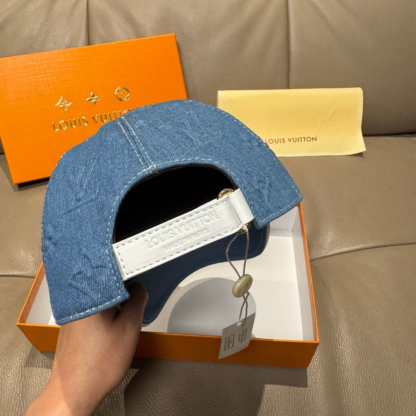 Blue denim cap with adjustable strap and white interior band