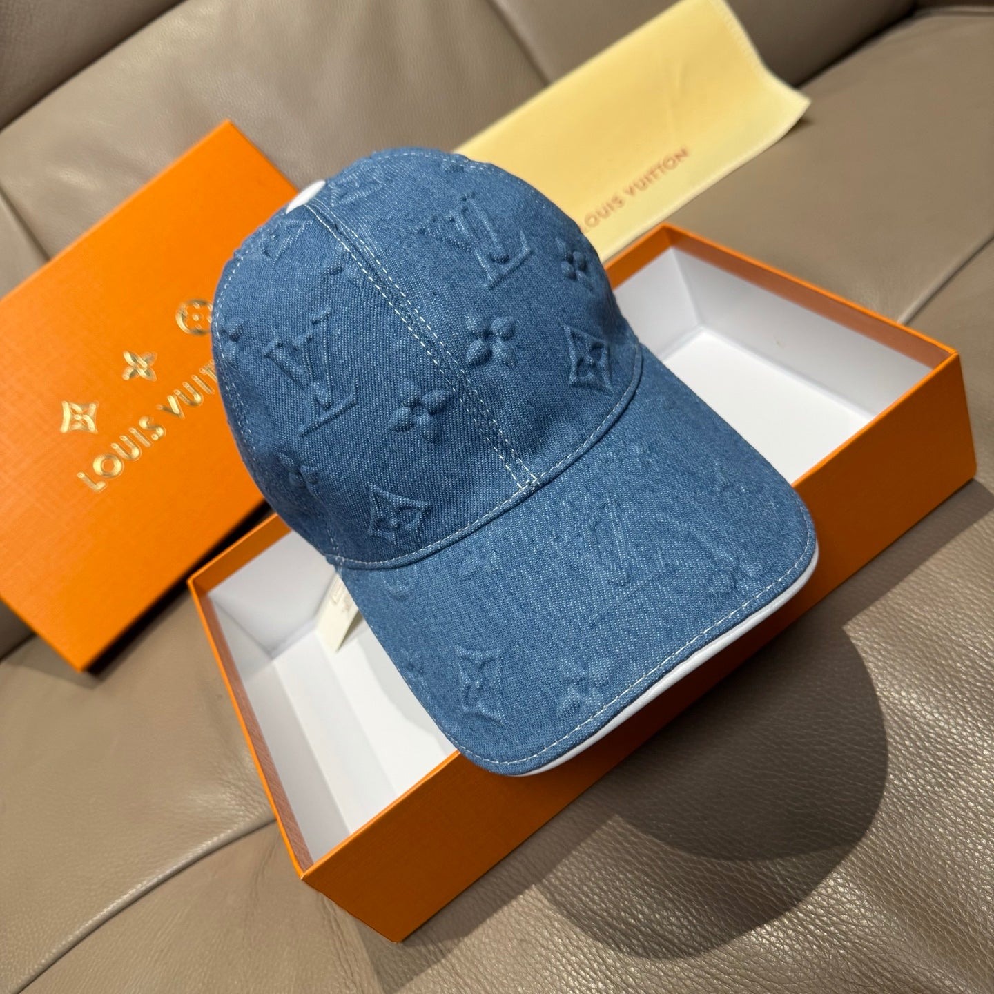 Blue denim cap with embossed LV monogram pattern and curved brim