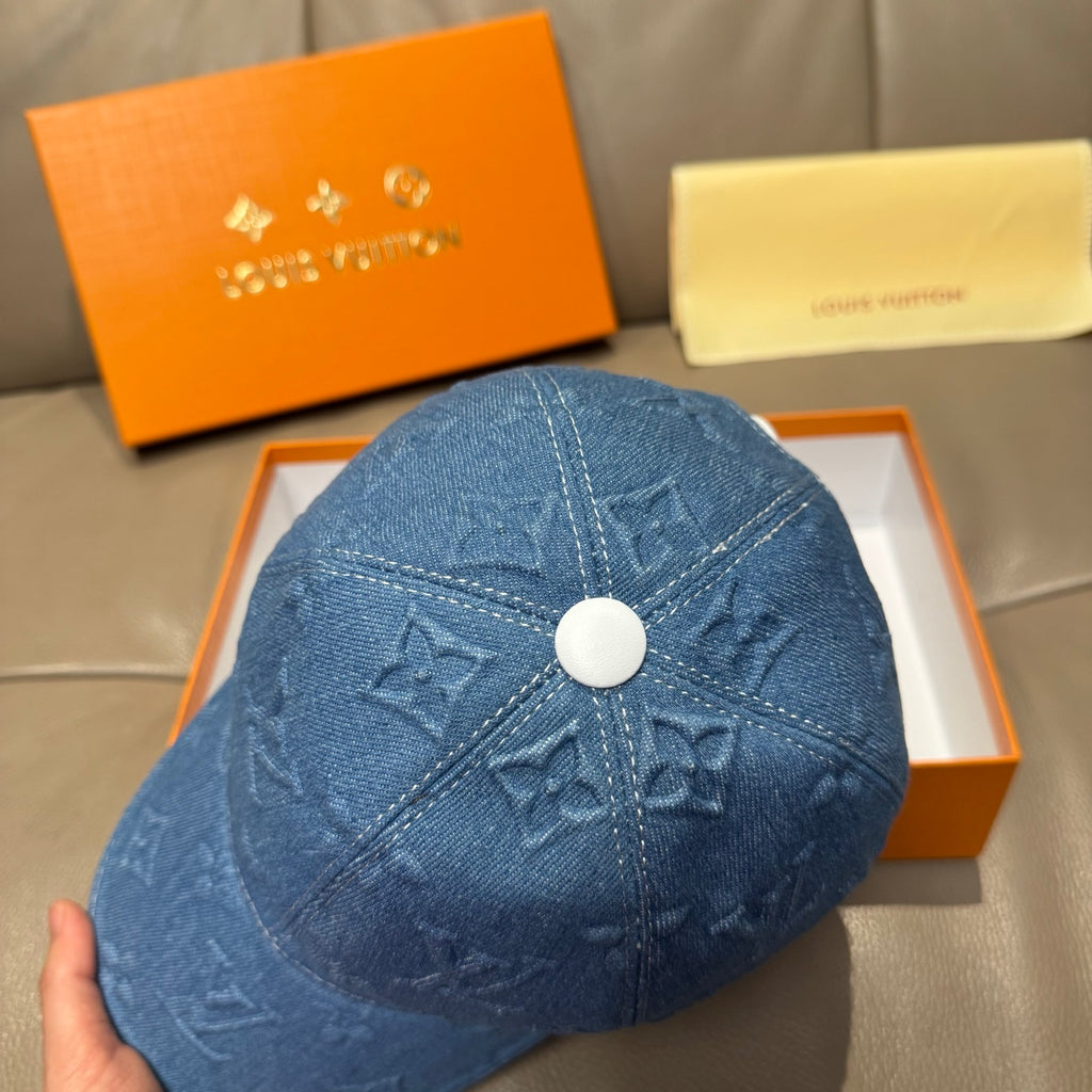 Blue denim cap top with embossed monogram pattern and round white button