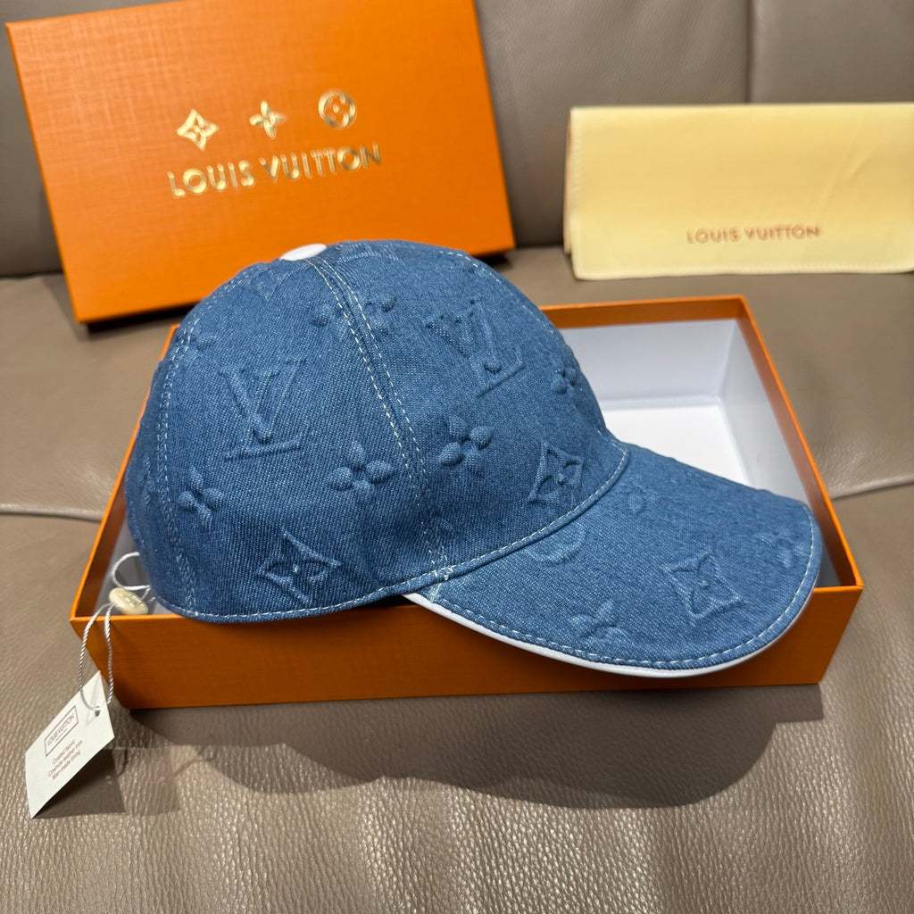 Blue denim baseball cap with embossed monogram motifs and curved brim