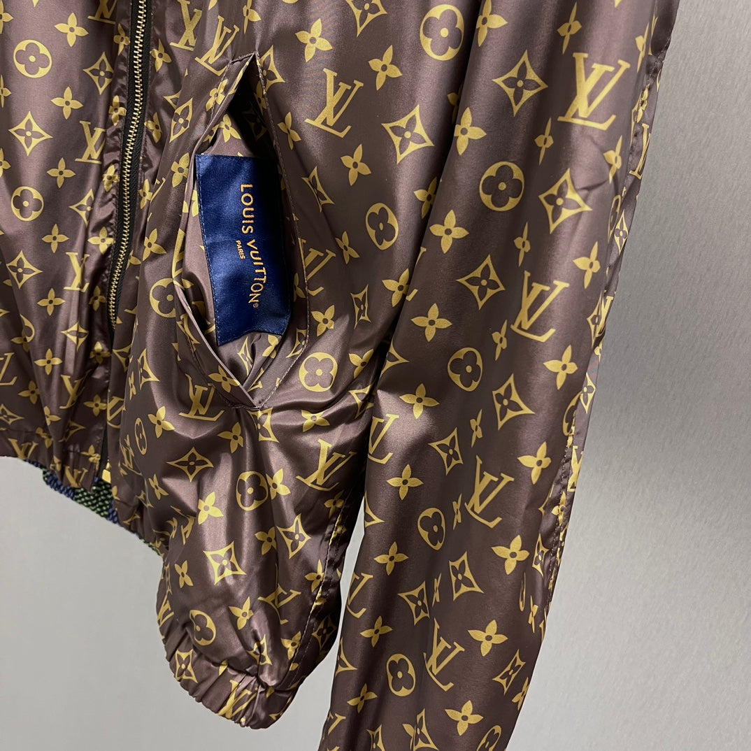 Brown monogram hooded jacket with drawstring waist and fabric tag at neckline