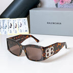 Tortoiseshell square sunglasses with dark lenses and gold EB logo temples