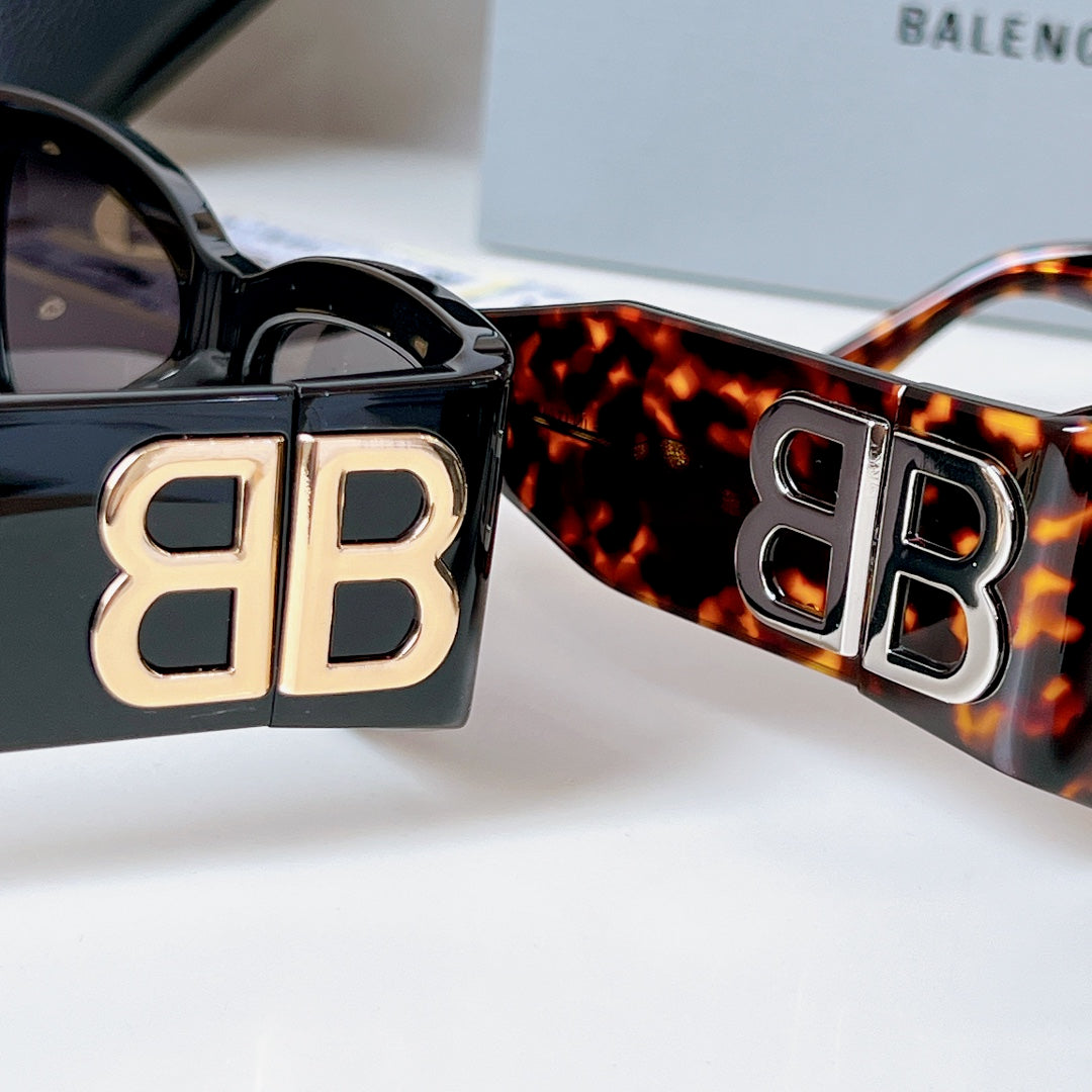 Tortoiseshell sunglasses with dark lenses and gold EB logo frame insert