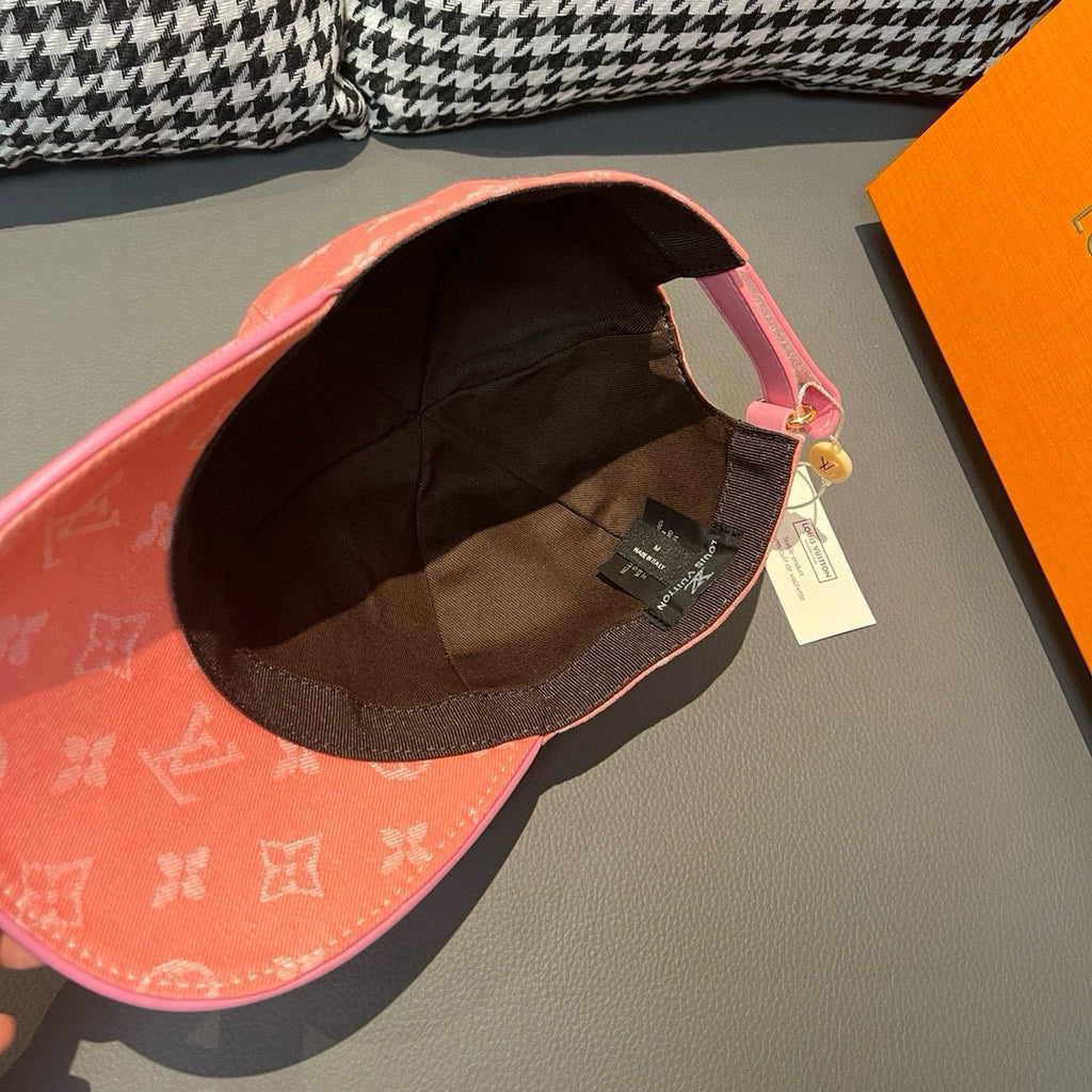 Louis Vuitton monogram cap in coral pink, interior view with black lining and hanging tag