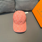 Louis Vuitton monogram cap in coral pink, front view with curved brim and panel seam