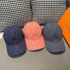 Three Louis Vuitton monogram baseball caps: dark blue, coral, and charcoal blue