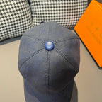 Louis Vuitton monogram denim cap in navy blue, domed crown with blue button