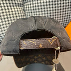 Black monogram baseball cap interior with tan leather strap detail