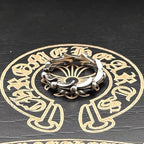 Silver-tone chrome cuff ring with twisted band and two clasp-like ornaments
