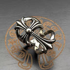 Chrome flower-shaped accessory with side ribbon detail and central bead