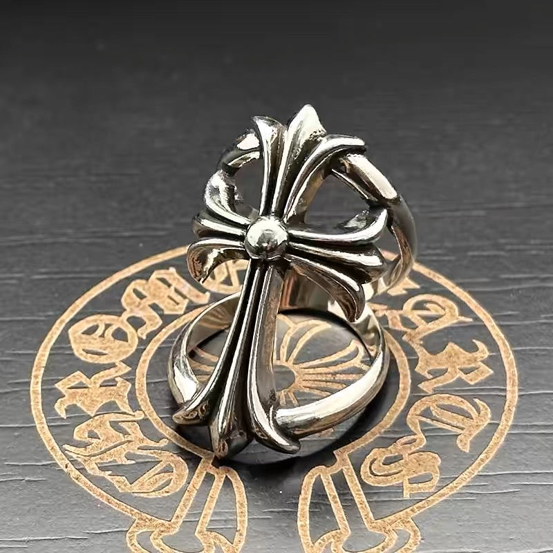 Chrome flower-shaped accessory with central bead and sculpted petal loops