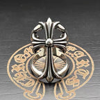 Chrome flower-shaped accessory with tall central spire and rounded petal loops
