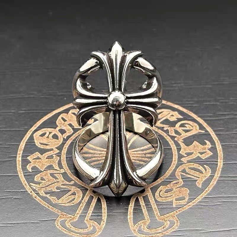 Chrome flower-shaped accessory with tall central spire and rounded petal loops