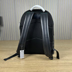 Coah backpack back view with padded black straps, top carry handle, and mesh panel