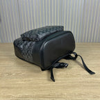 Coah duffel-style backpack with patterned body, black end panels, and shoulder strap
