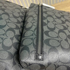 Coah backpack close-up of center zipper and monogram-patterned side panel